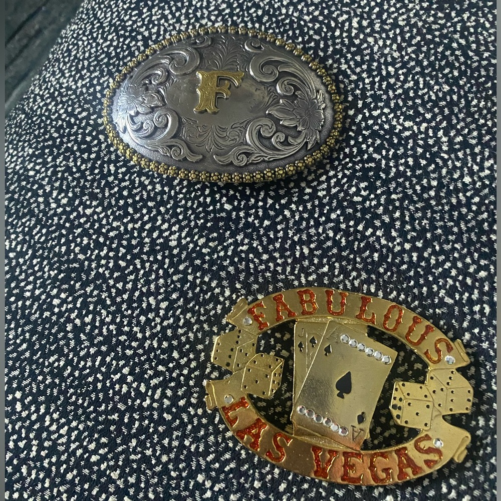 2 very cool belt buckles.  One with the initial F. The other Fabulous Las Vegas